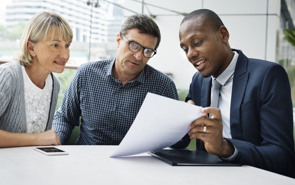 older couple reviewing documents with financial planner