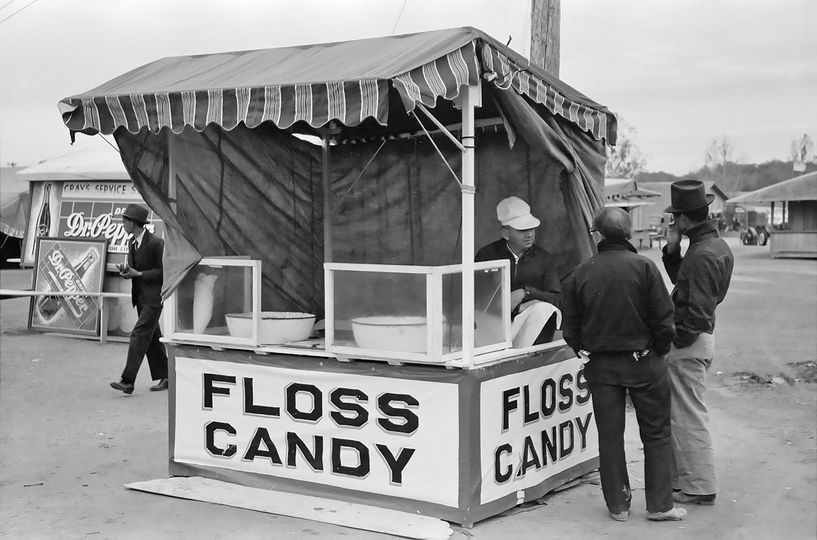 Floss Candy stand at the Gonzales County Fair in 1939. Although machine spun cotton candy was first made in 1897 the modern cotton candy machine was invented in September 1905.