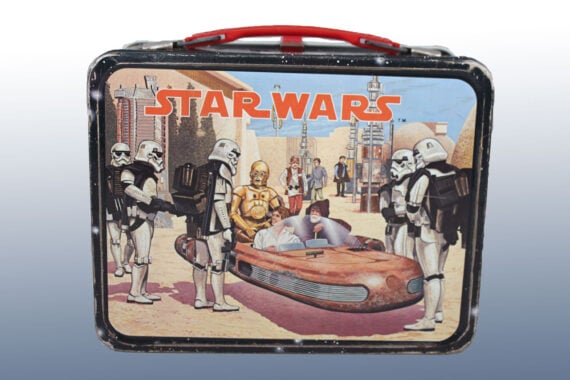 A vintage Star Wars lunchbox featuring Stormtroopers, C-3PO, R2-D2, and Luke Skywalker in a desert town scene with a landspeeder—a classic addition to any collection of vintage lunchboxes.