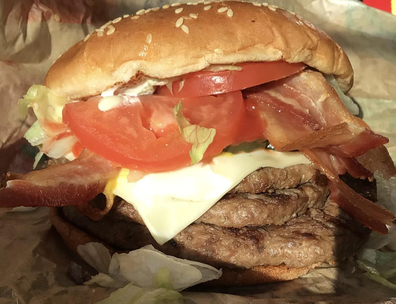 Triple whopper with bacon, Swiss cheese, and mustard