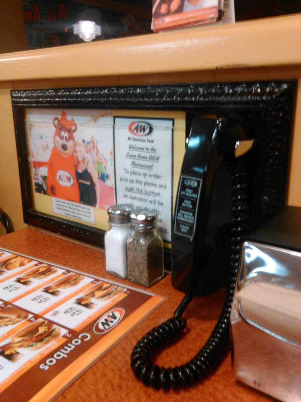 Phoning in your order at A&W from the table