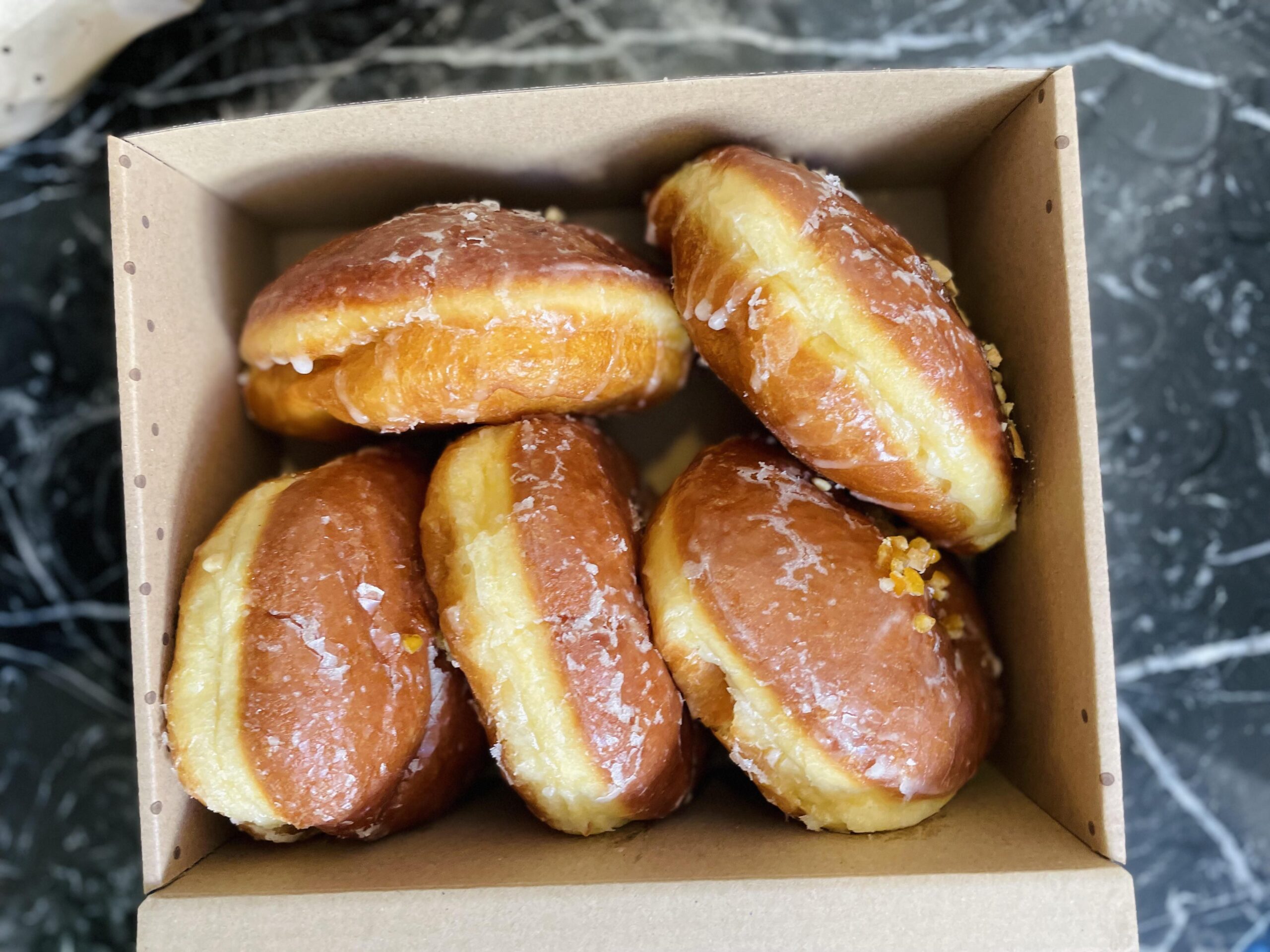 Paczki. Warm Polish donuts filled with rose flavored jam, Ferrero Rocher & salty carmel.