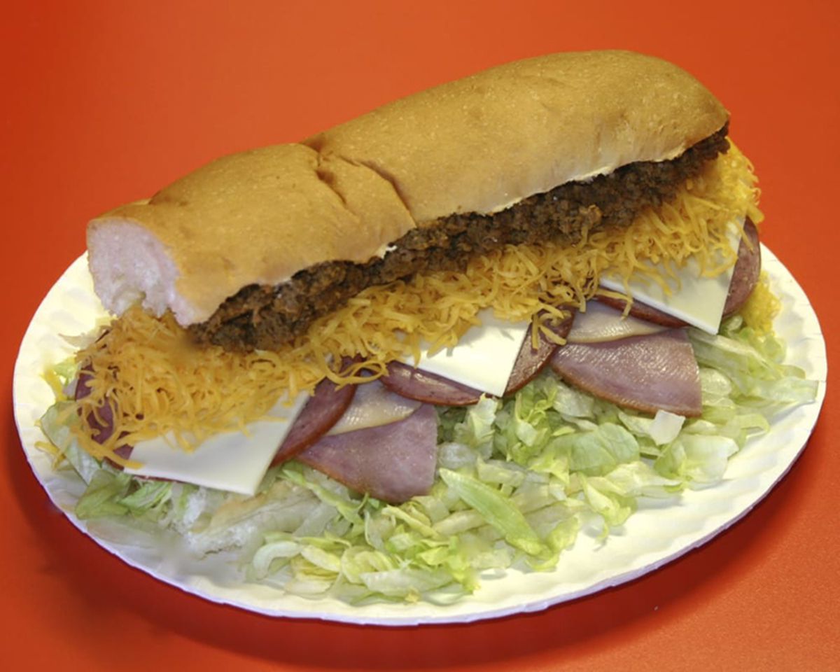 Everything Grinder Sandwich on a white paper plate, The Red Pepper, Grand Forks, North Dakota, on a red table