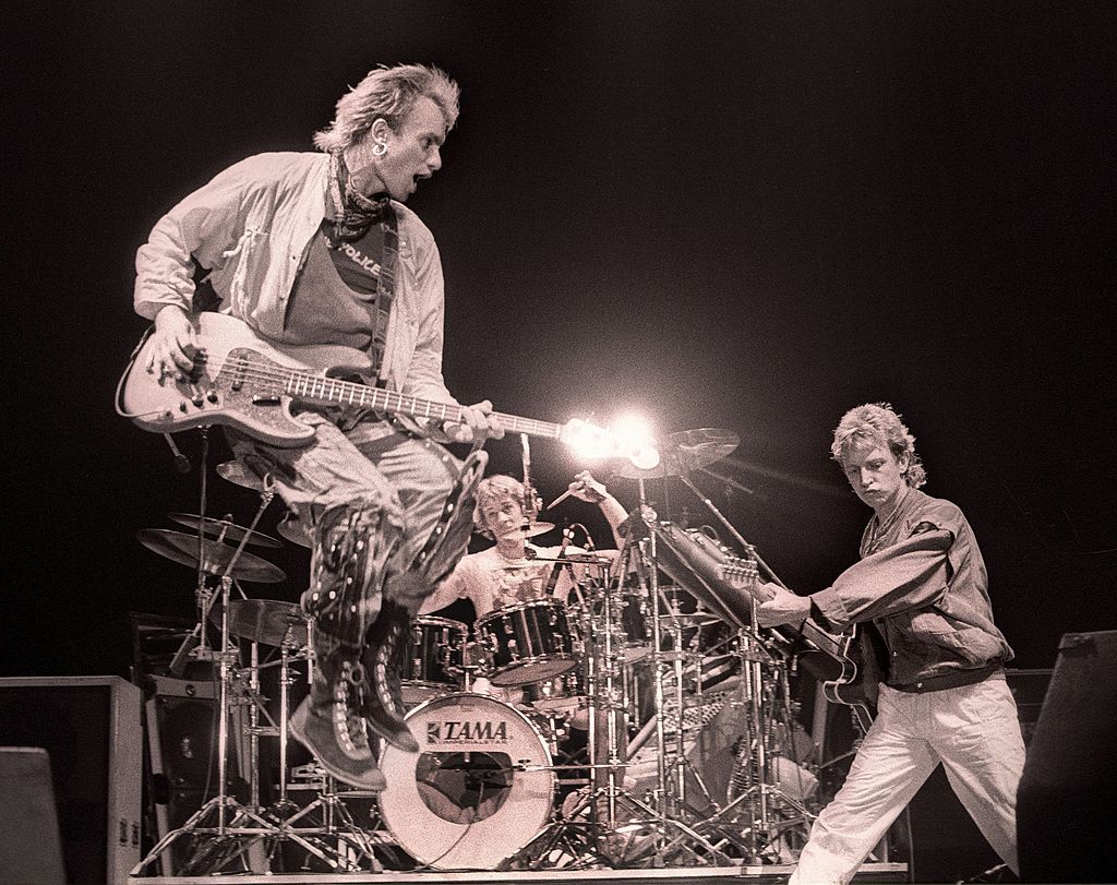 A black and white photo of the band The Police play a concert in the Netherlands in 1983.