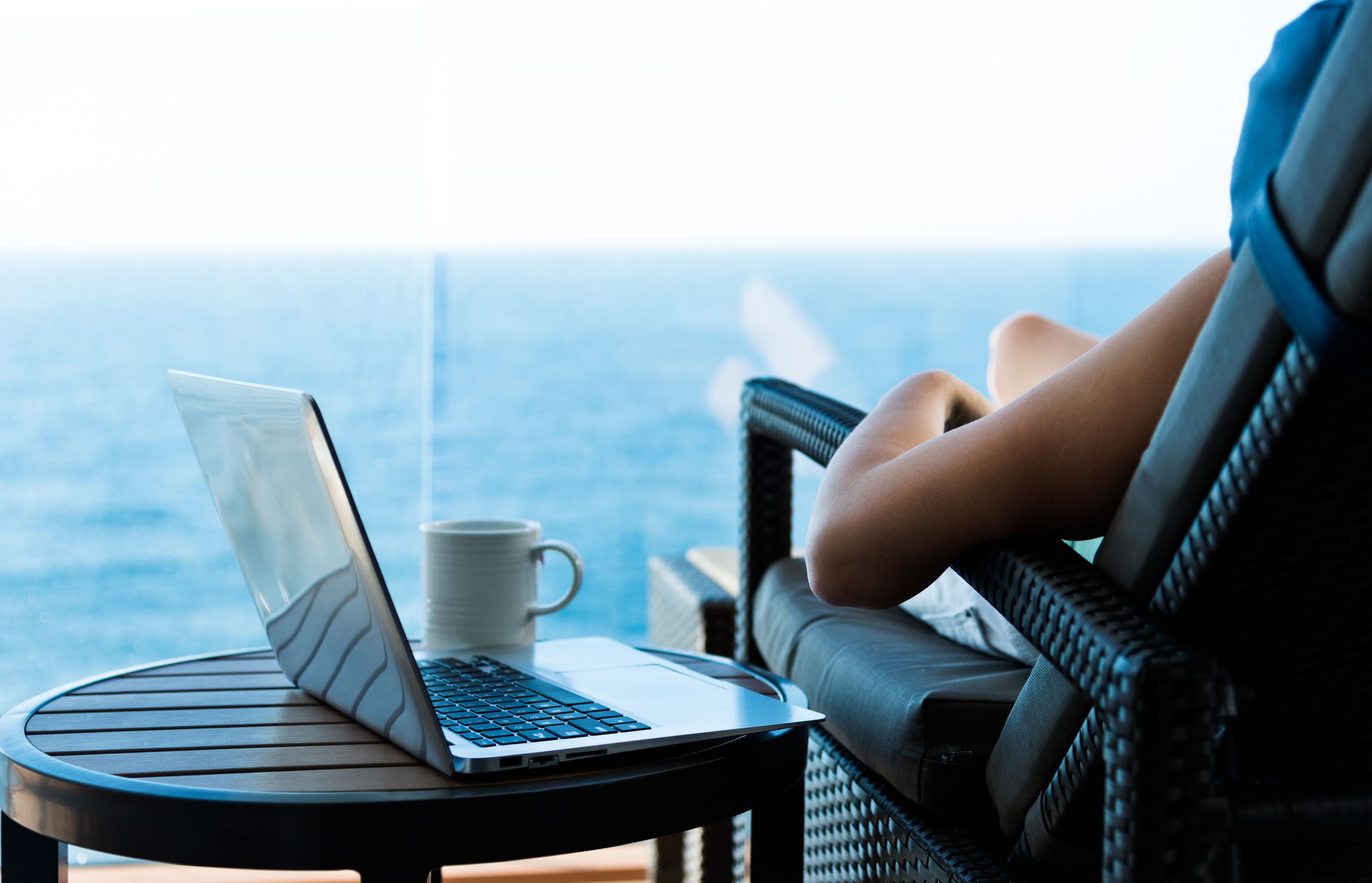 Woman working with a laptop on cruise ship.