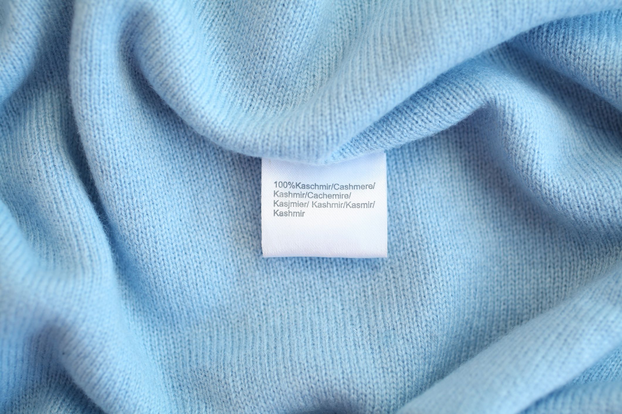 light blue cashmere fabric closeup with tag 100% cashmere
