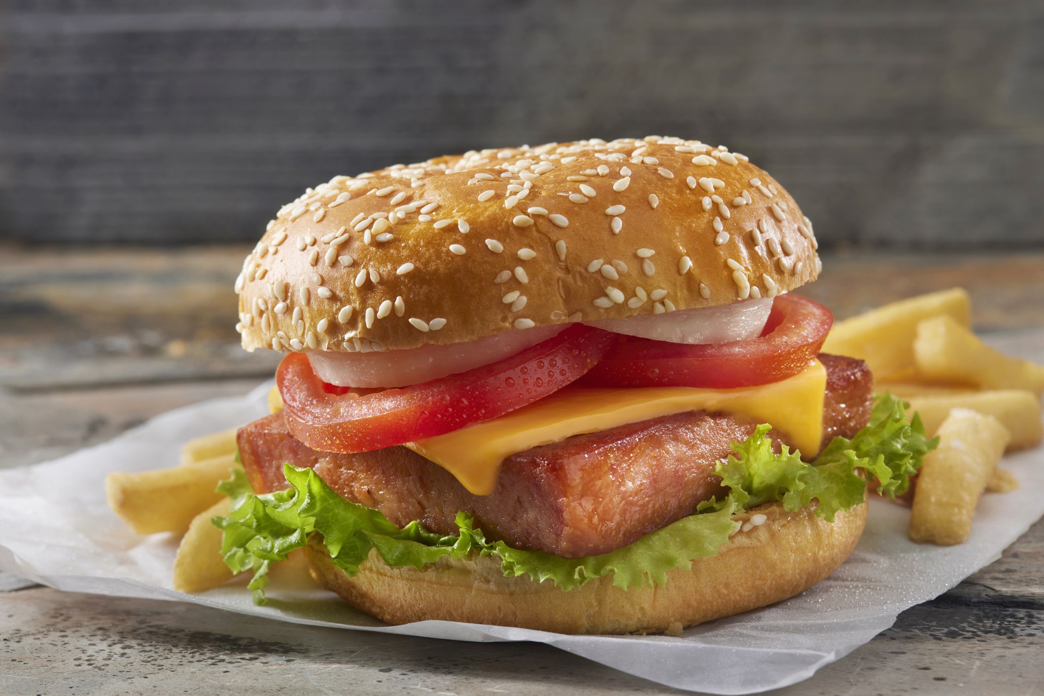 Grilled Spam Burger with Lettuce, Tomato, Onions, Sliced Cheese, Mustard and Fries
