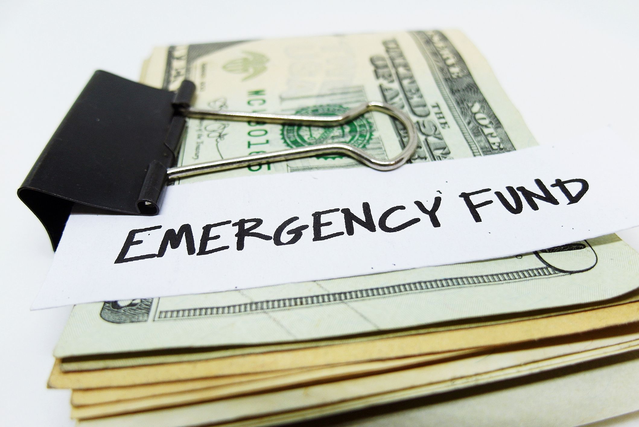 Money clip with note EMERGENCY FUND, concept of smart financial planning start by saving money for unexpected financial crisis