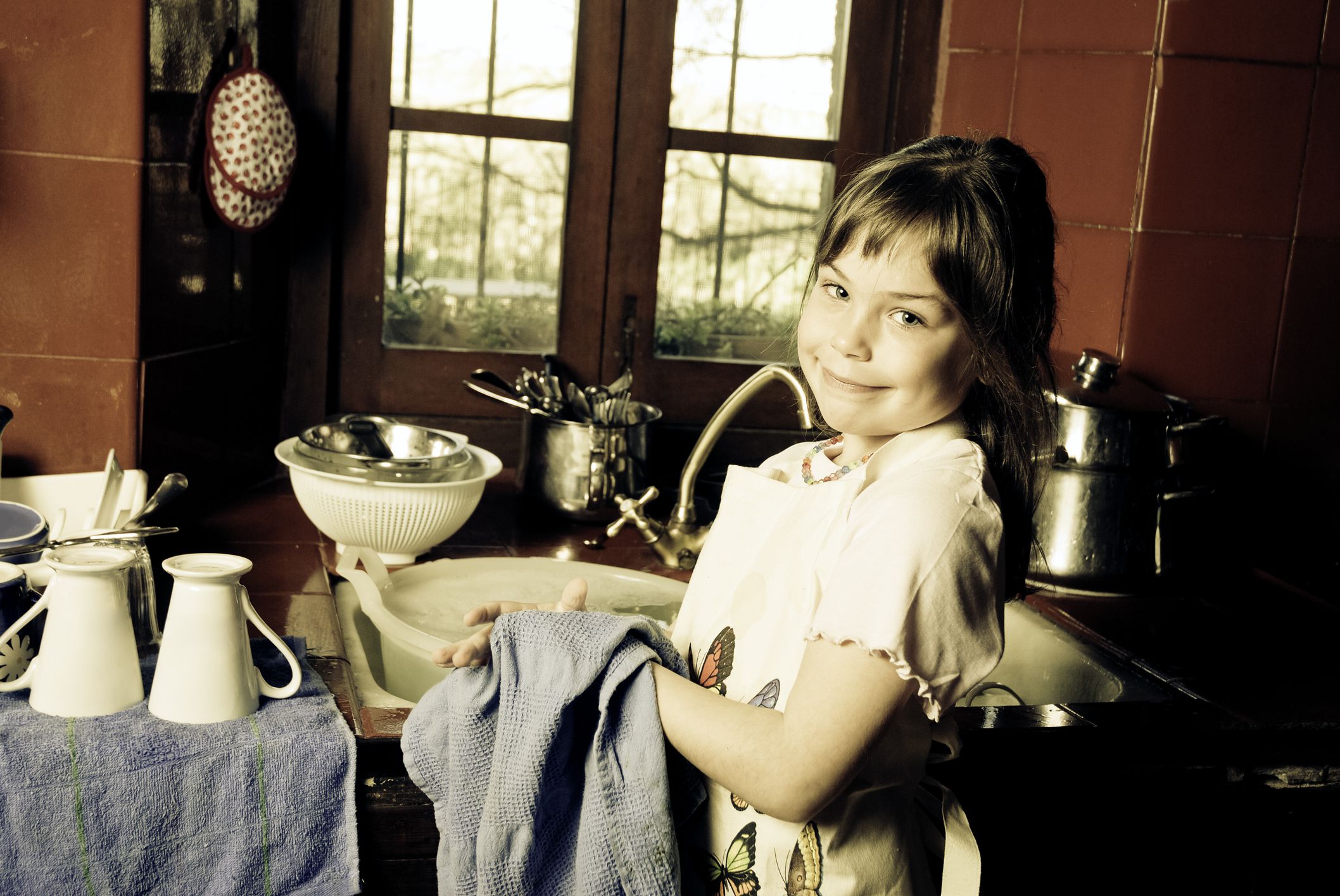 Young girl helping wuth home chores.