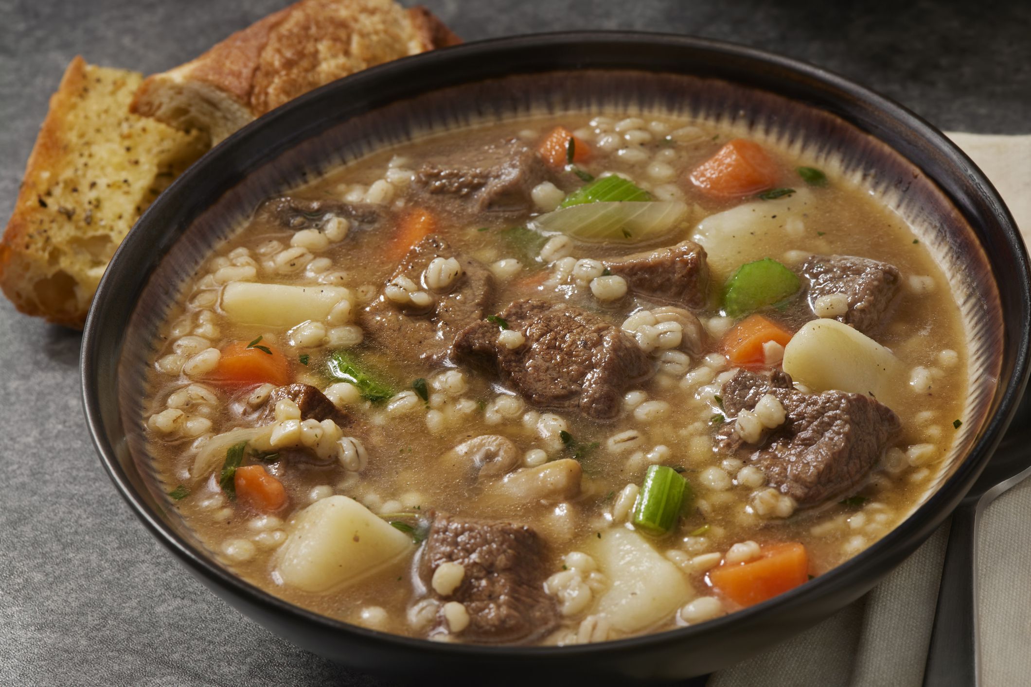 Beef and Barley, Vegetable Soup with Mushrooms, Onions, Potatoes, Carrots, Celery and Garlic Bread
