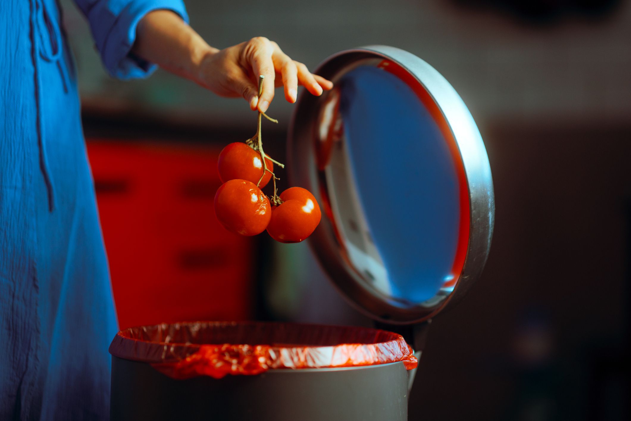 Girl throwing away rotten veggies with eco properties