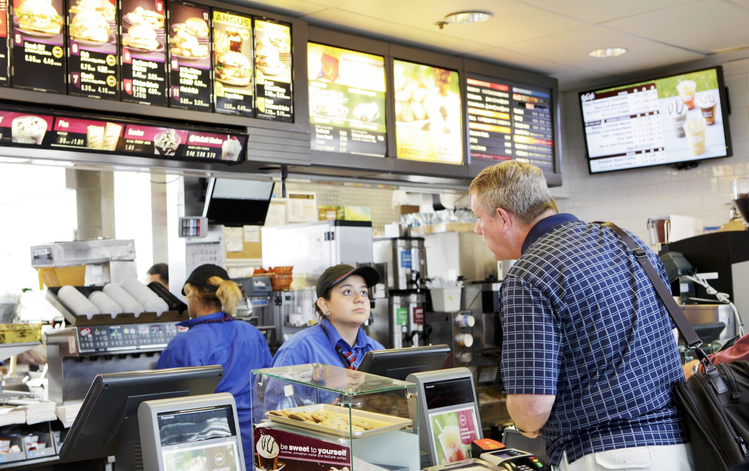 Chicago, USA - September 12, 2011: Traveler passing through Chicago O\'Hare International Airport terminal orders fast food from McDonalds.