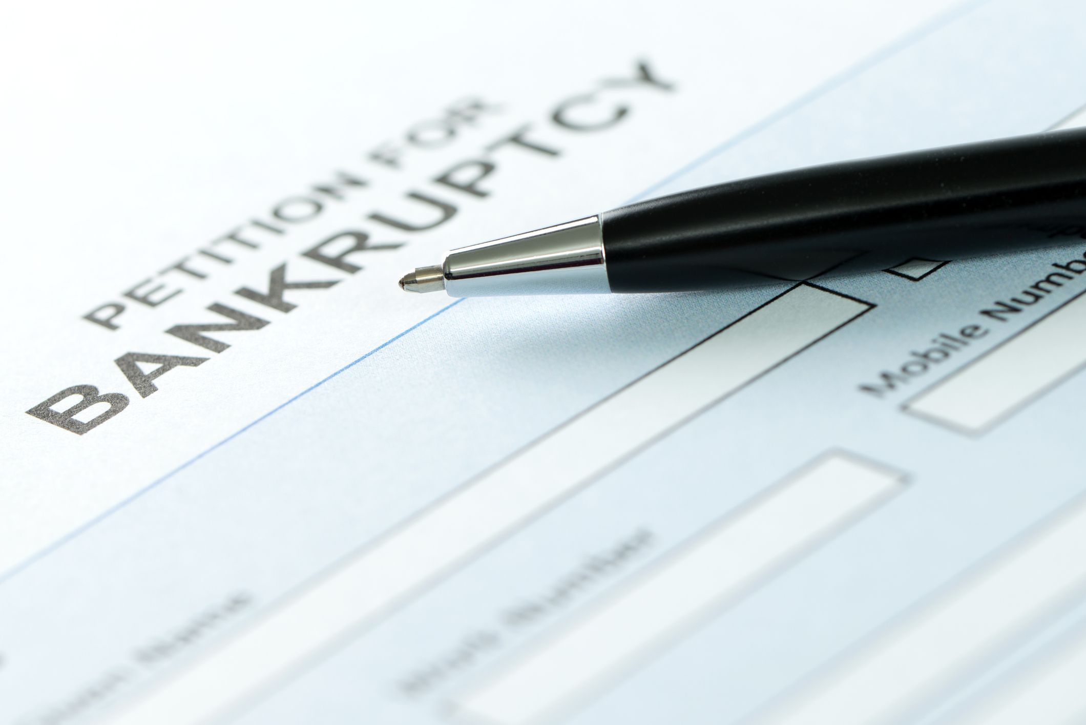 Close up of petition for bankruptcy form and pen