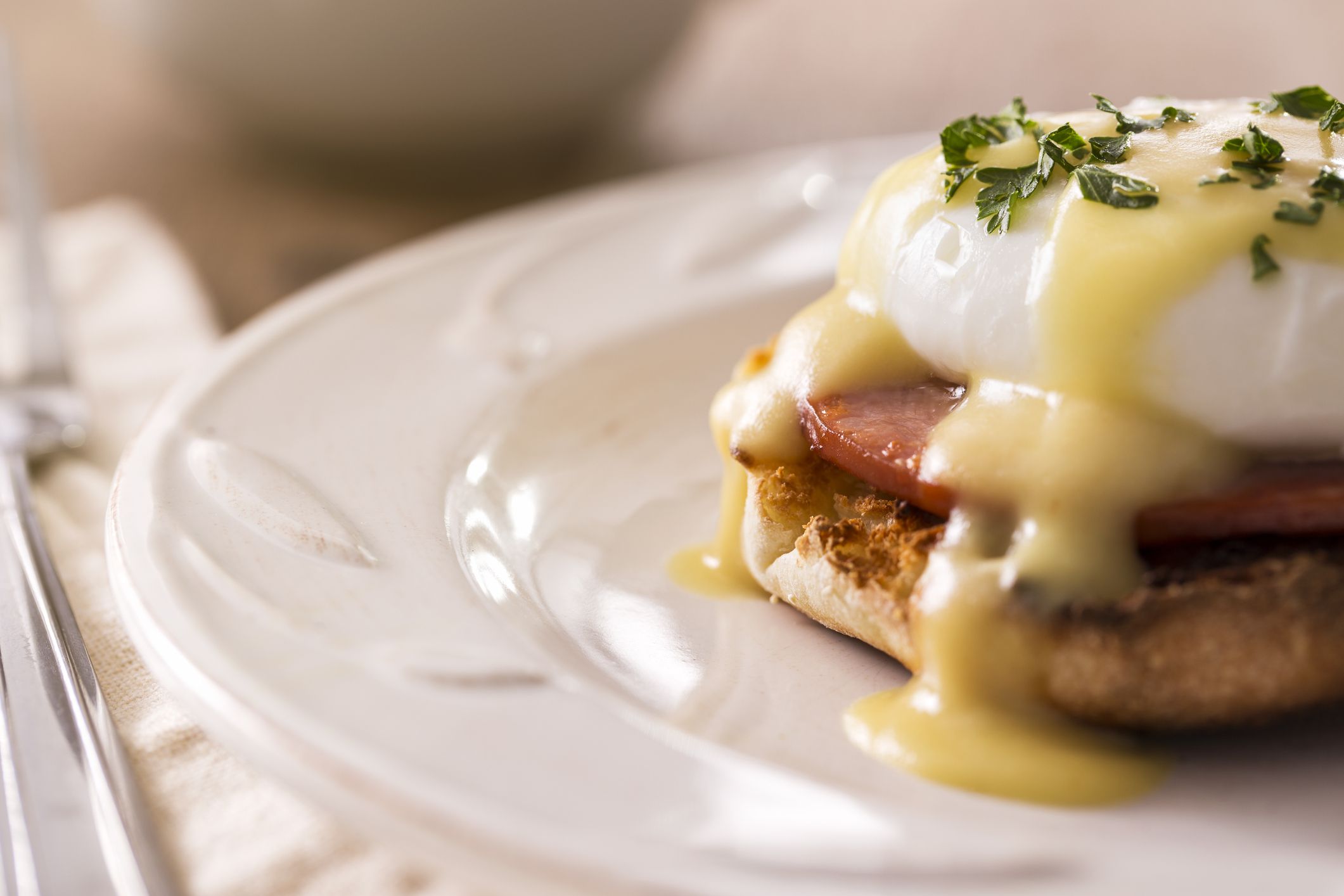 Morning Breakfast - Eggs benedict with hollandaise sauce. Eggs benedict is a dish made with a poached egg, ham, and toasted english muffin with hollandaise sauce on top. Please see my portfolio for other food and drink images.