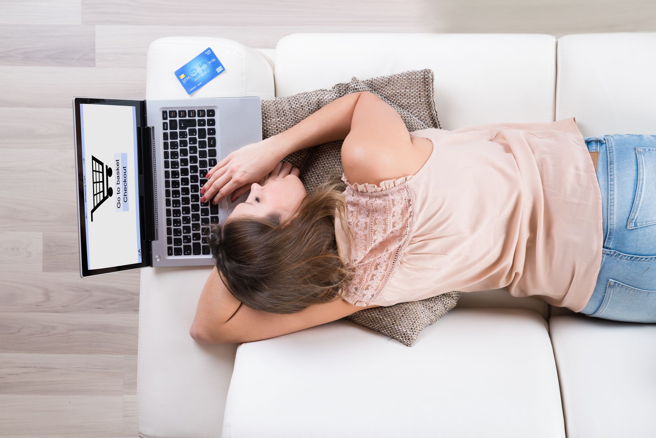 Young Woman Sleeping With Laptop While Shopping Online