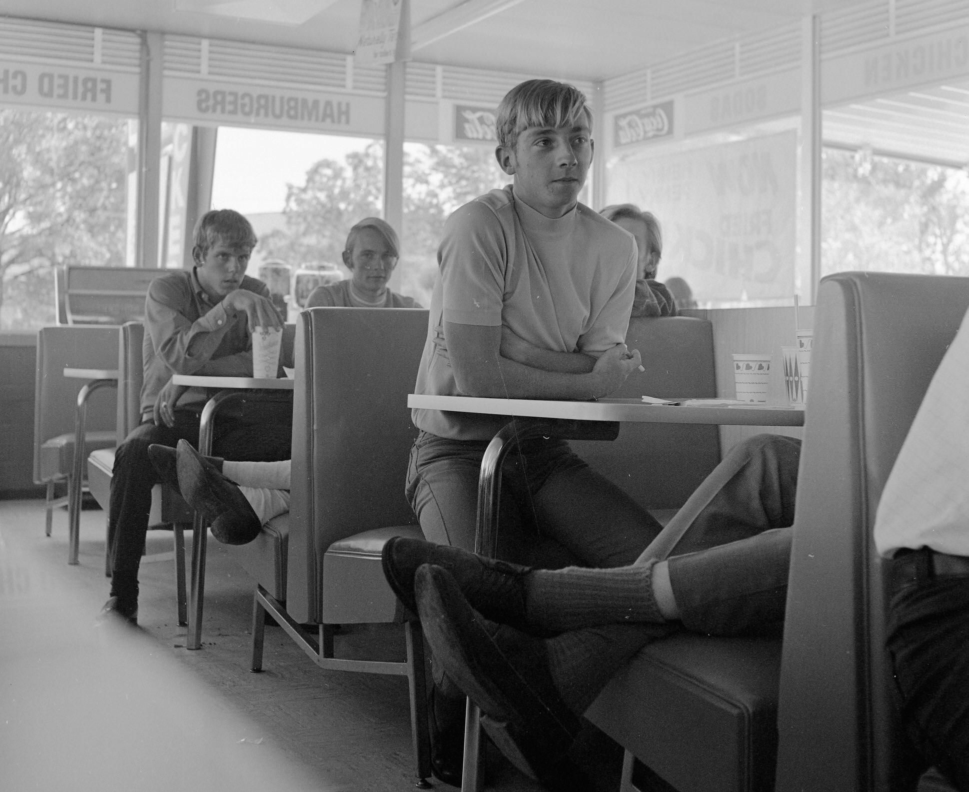 My dad (far left holding the cup) finishing up his 2 burgers, fries, and a large drink that he got for a $1.00 in a local diner. ~ 1970