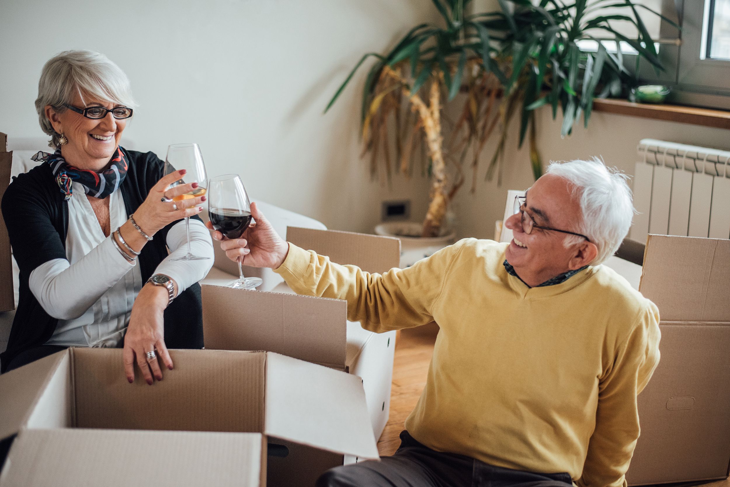 happy elderly couple moving to new apartment
