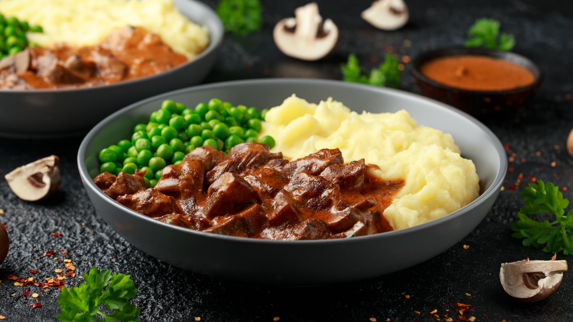 Sliced steak diane with peas