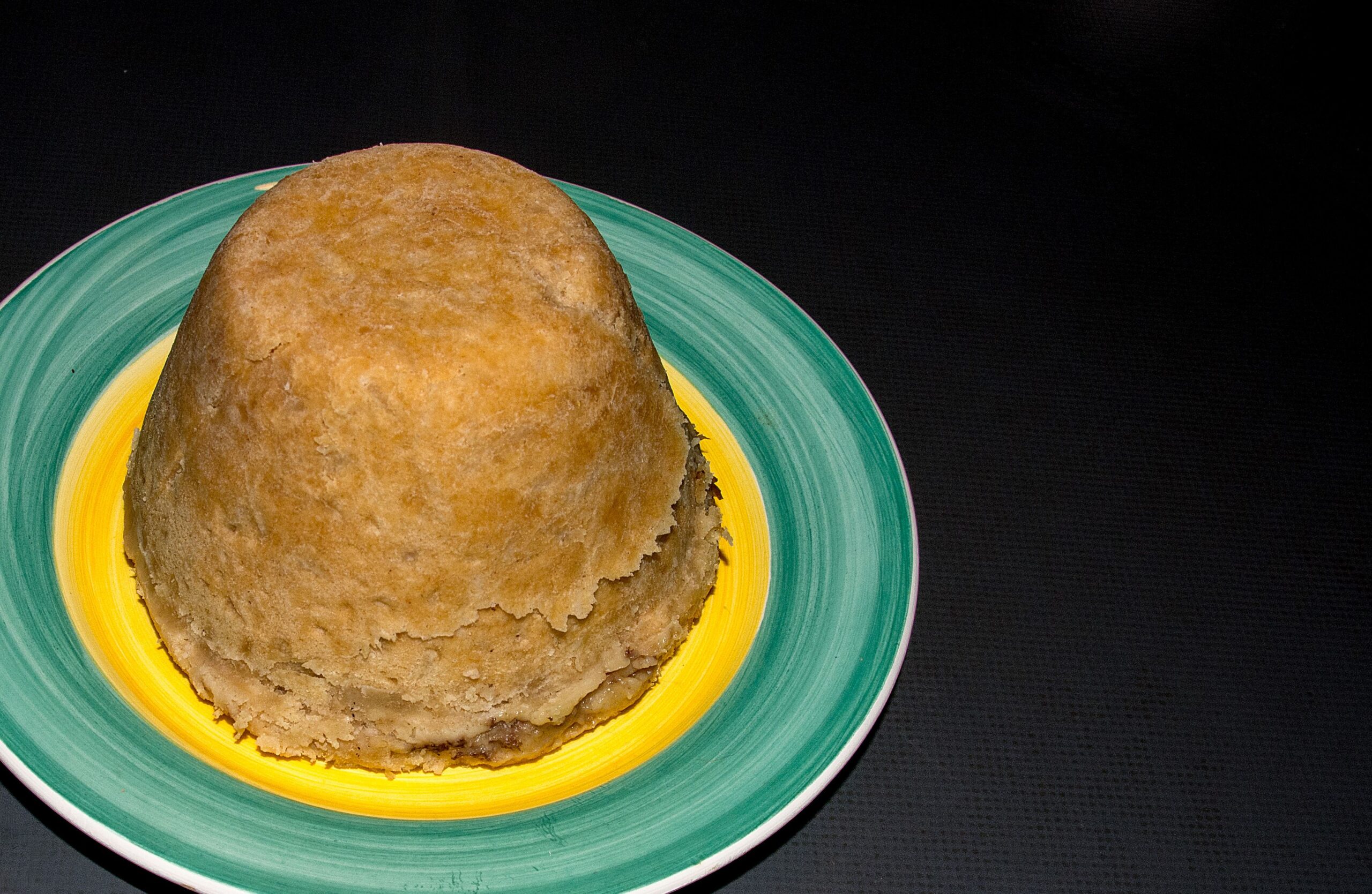 a steak and kidney pudding on a plate