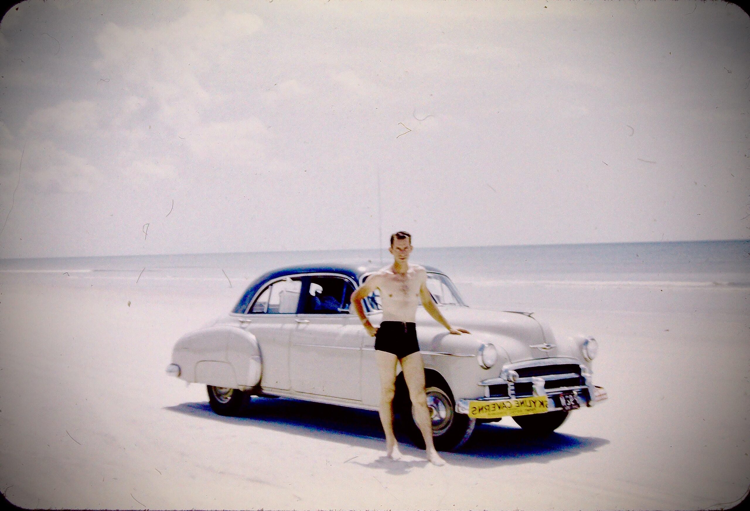 My grandfather on vacation. Estimating on the following: taken in the mid 50s, early 50s Chevy, somewhere on the East coast of Maryland, USA.