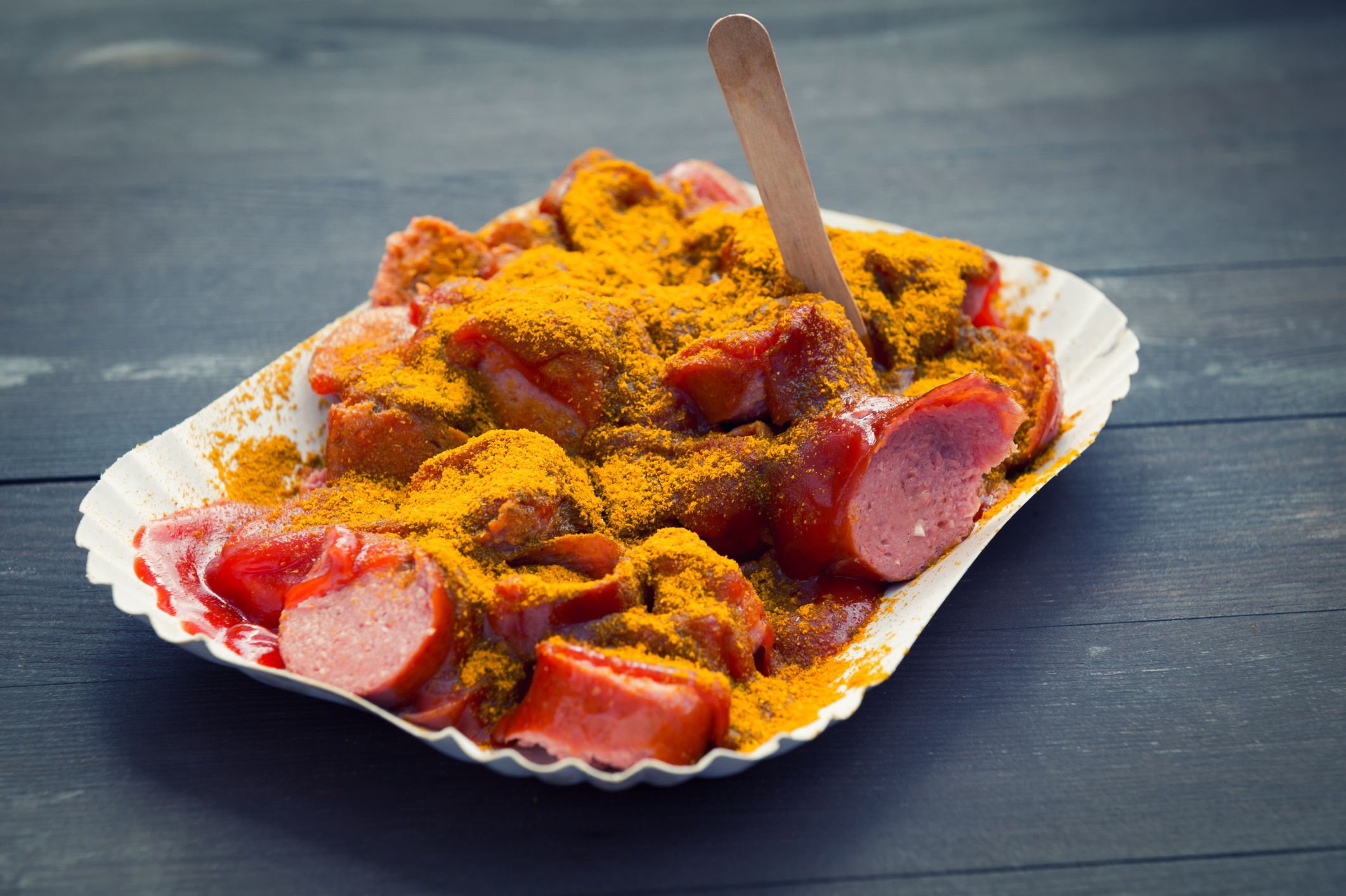 curried sausage in a disposable plate