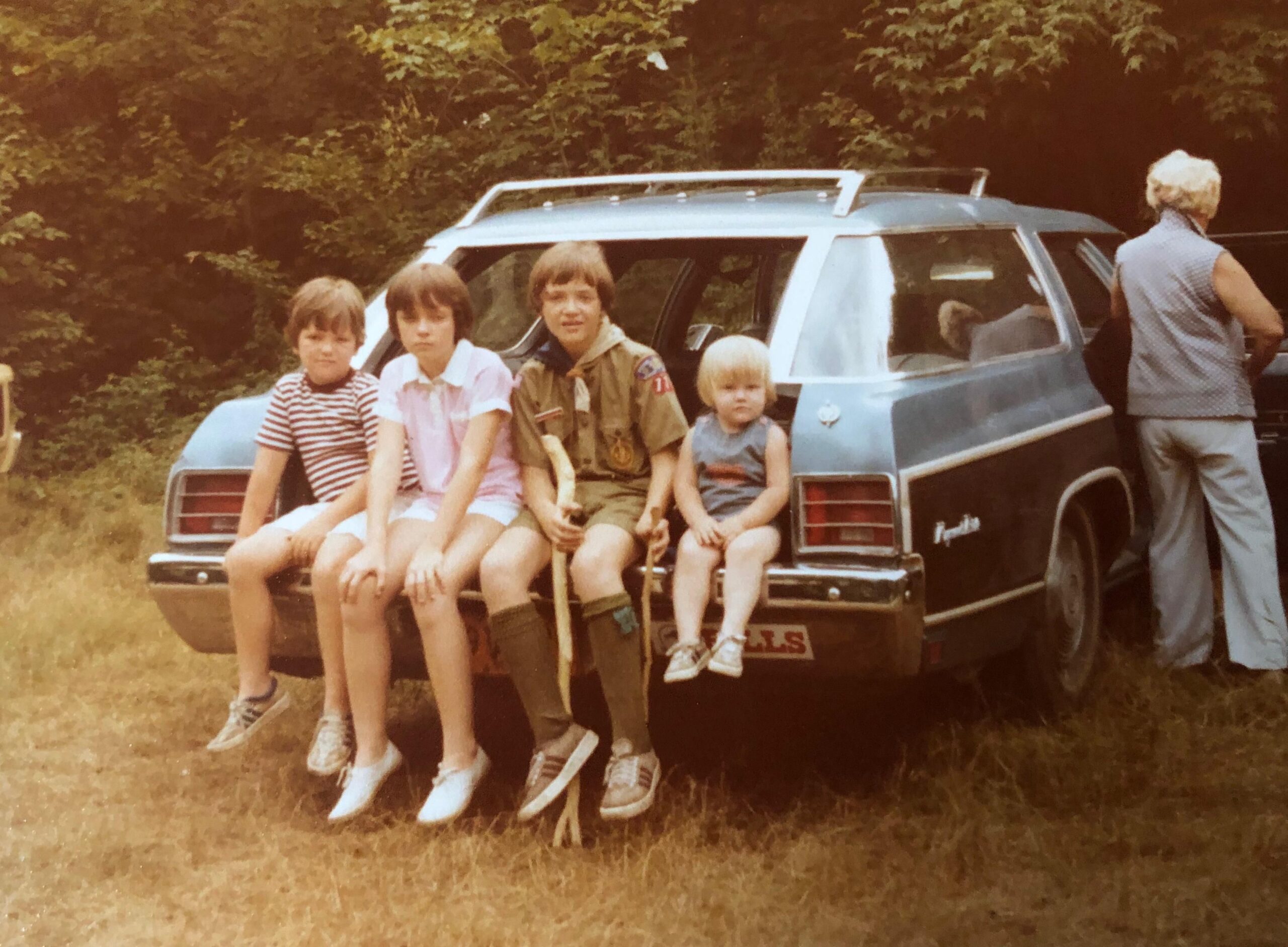 family in the way back of a car in the 1980s