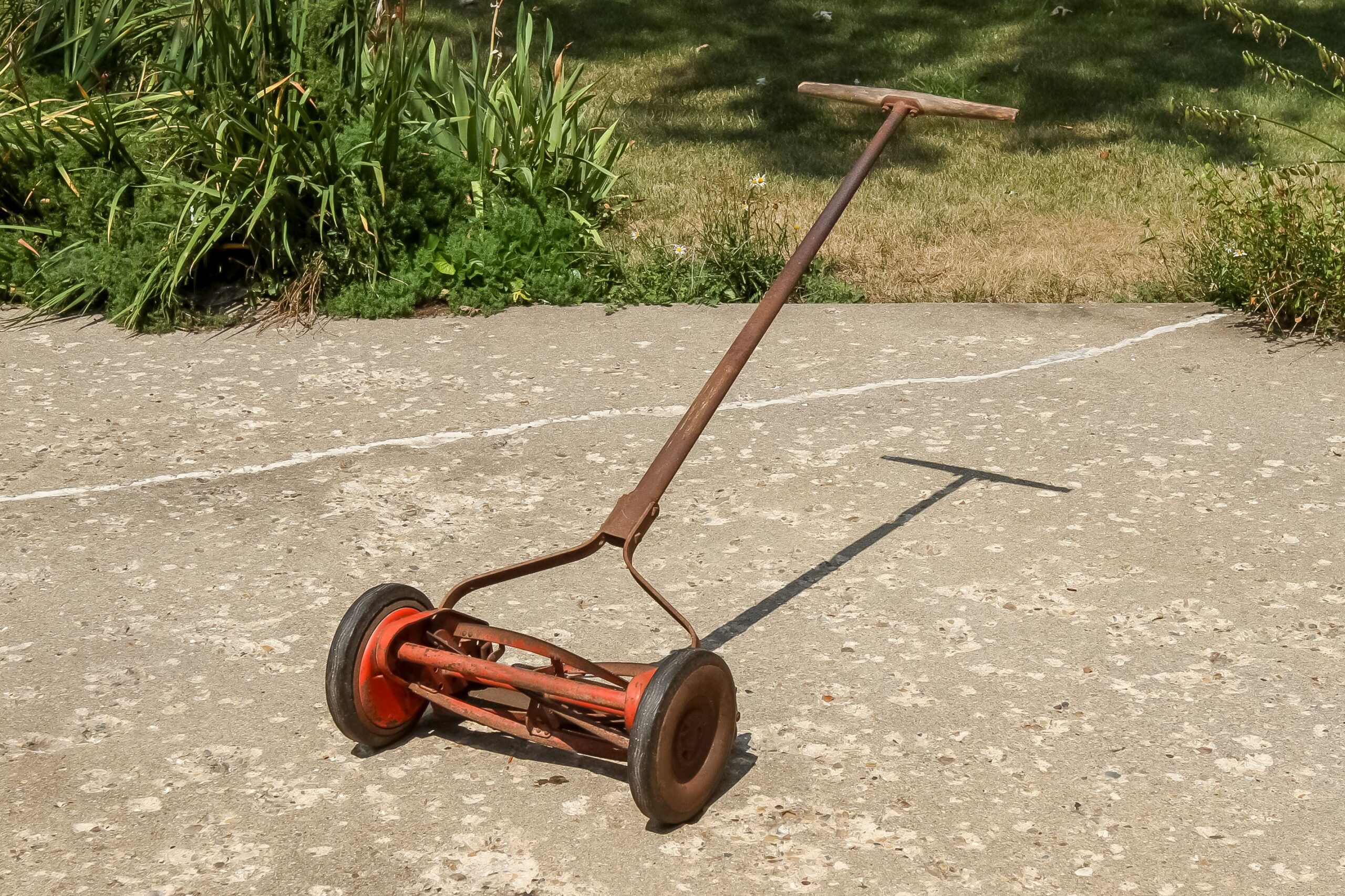 a full view of a reel lawnmower before the paint was removed