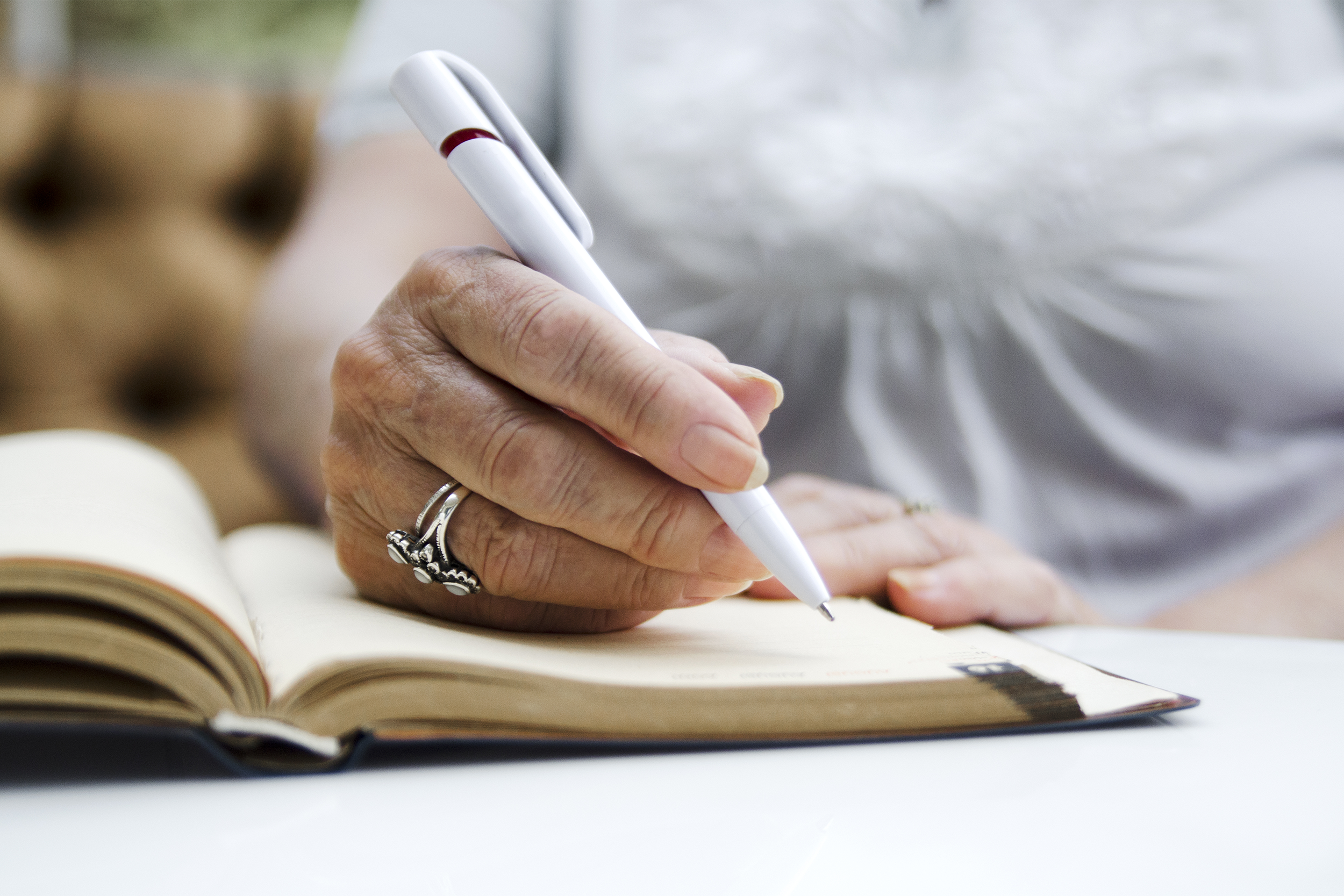 senior woman writing in notebook