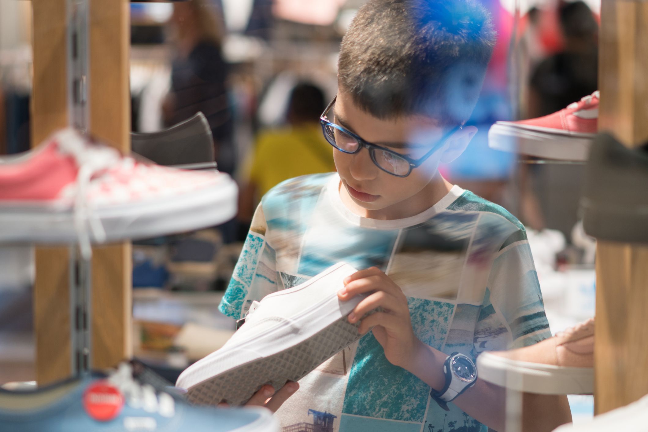 Boy Shopping for New Shoes in shoes store
