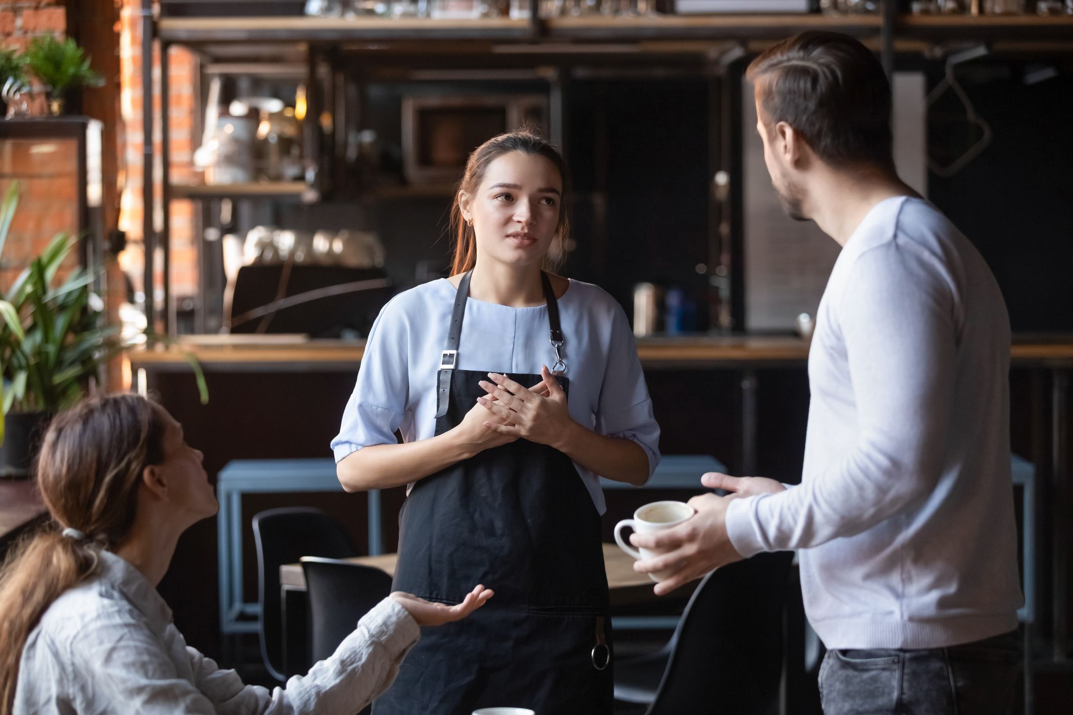 Hostile angry restaurant client couple or friends talking with waiting staff in public place complains about cold coffee long service, spoiled tasteless dish waitress feels guilty mixed orders concept