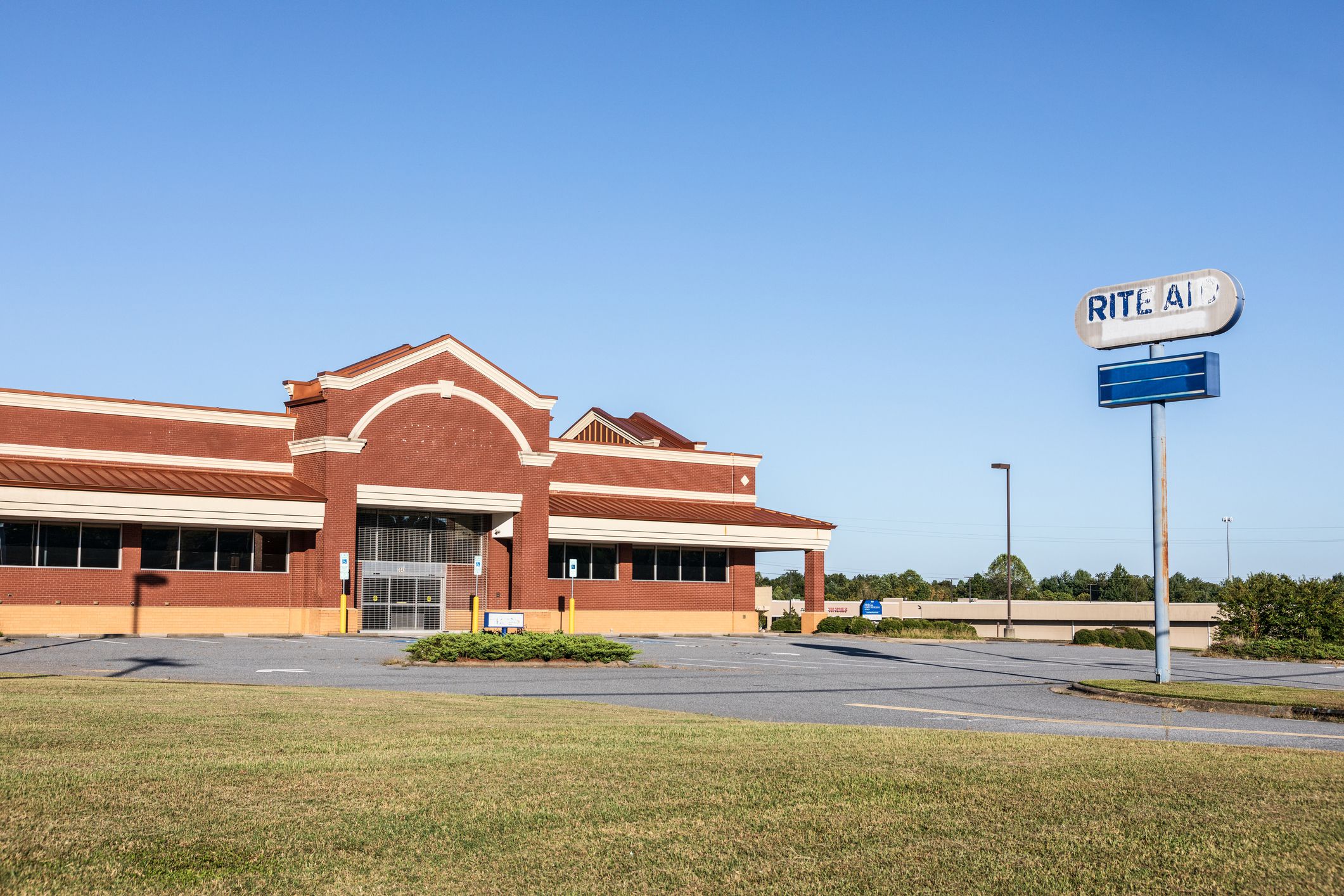 Hudson, NC, USA-24 Sept 2019: A closed Rite Aid pharmacy, building and road sign.