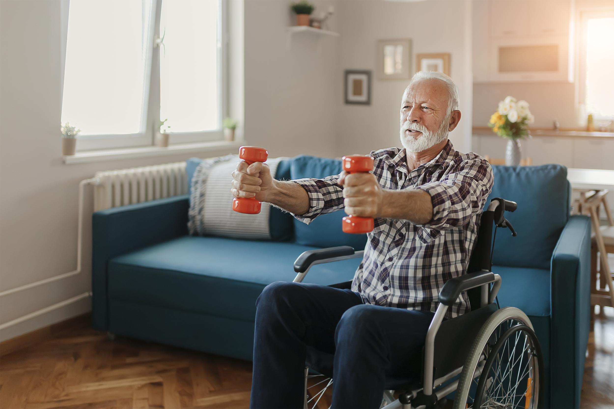 senior man in wheelchair lifting weights
