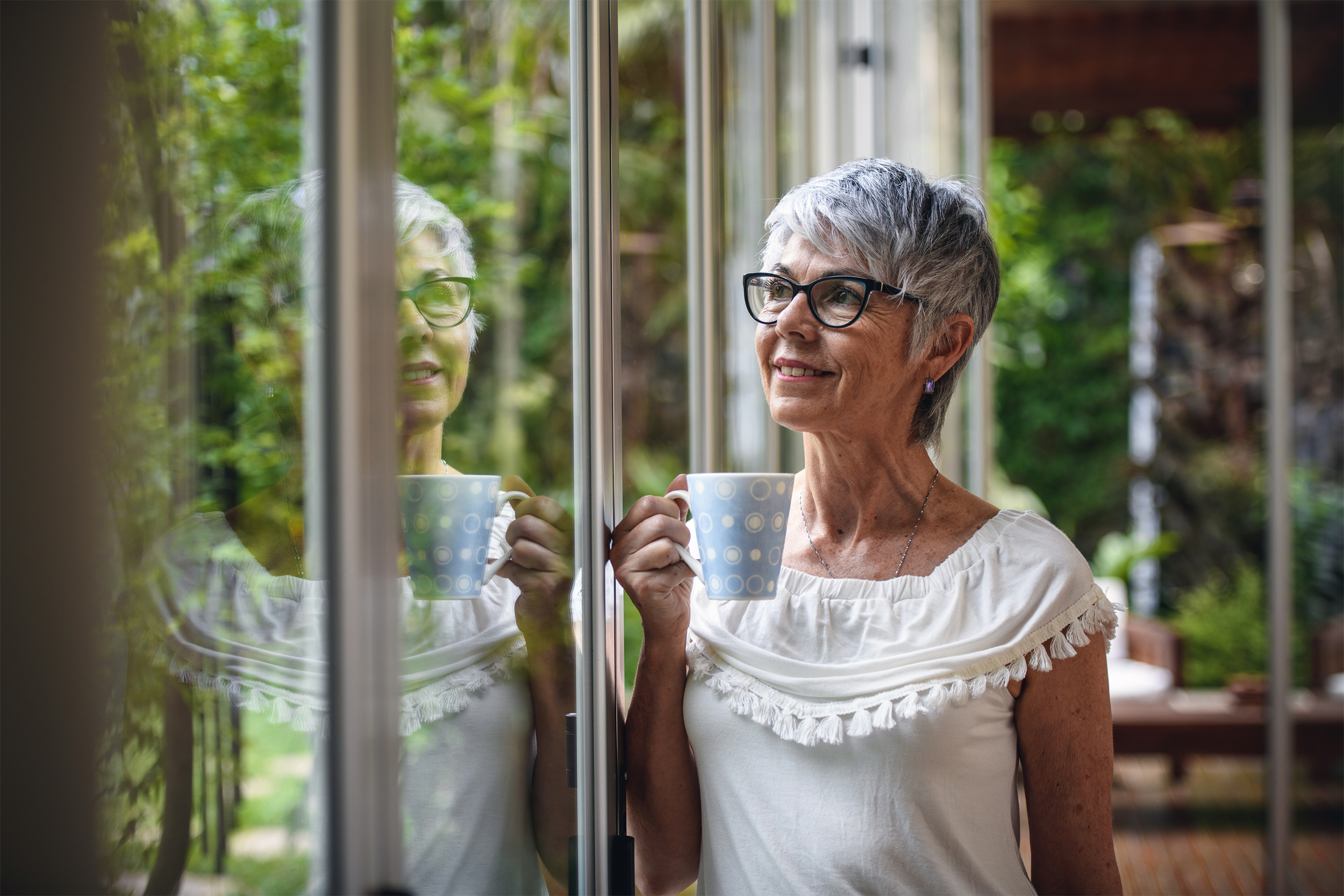 senior woman looking out window
