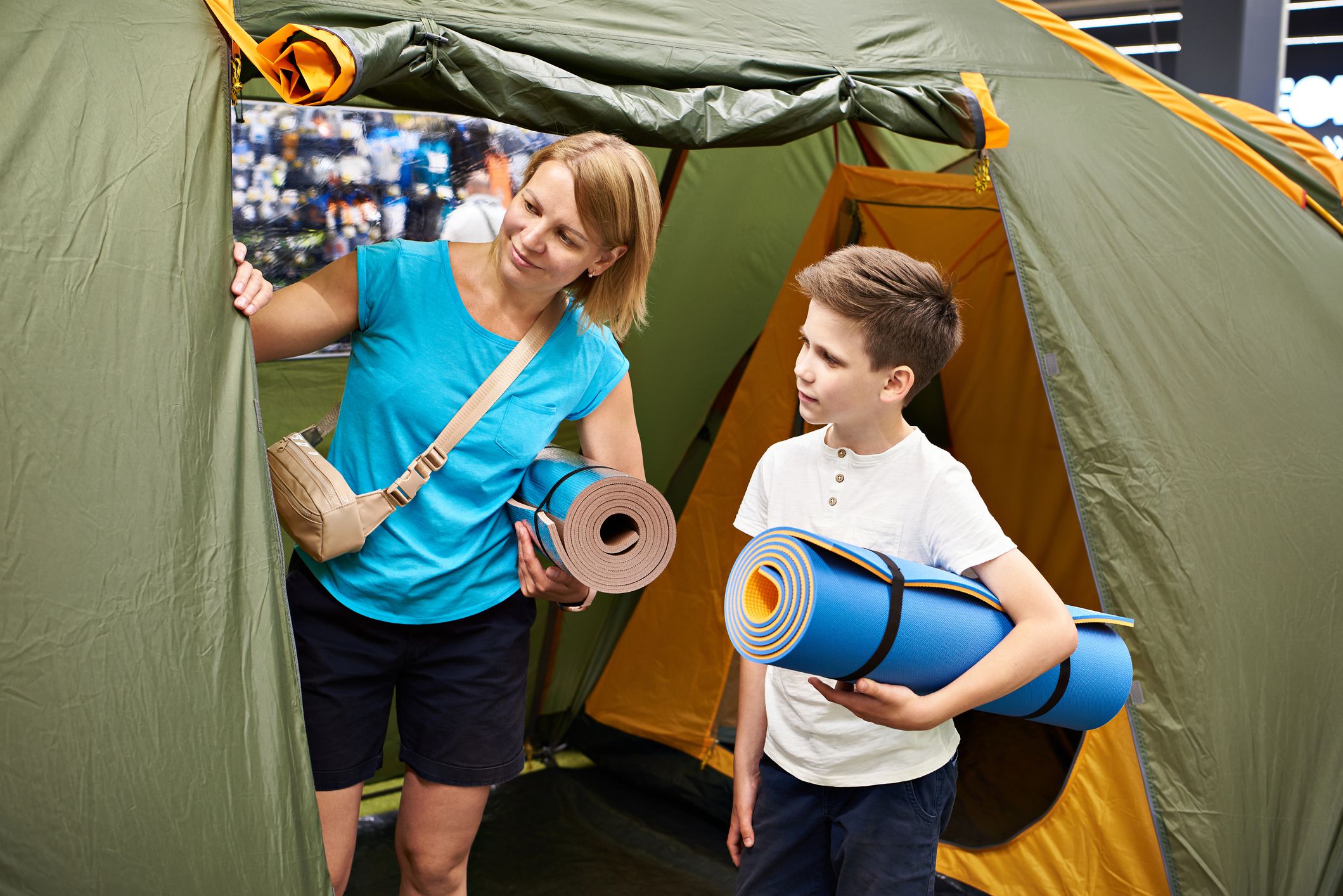 Mom and son choose a camping tent in store