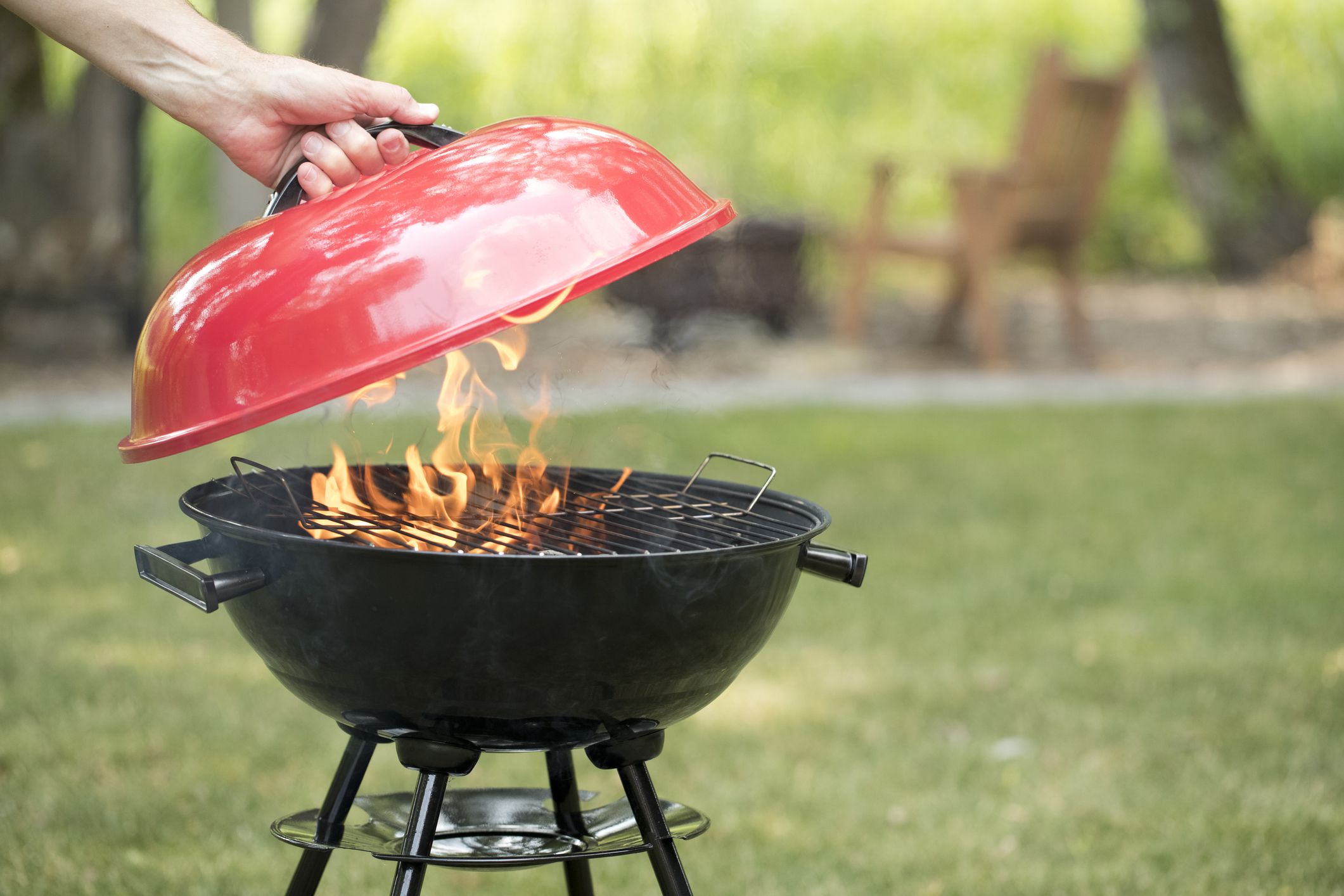 Red Generic Brand Barbecue Grill in the backyard.