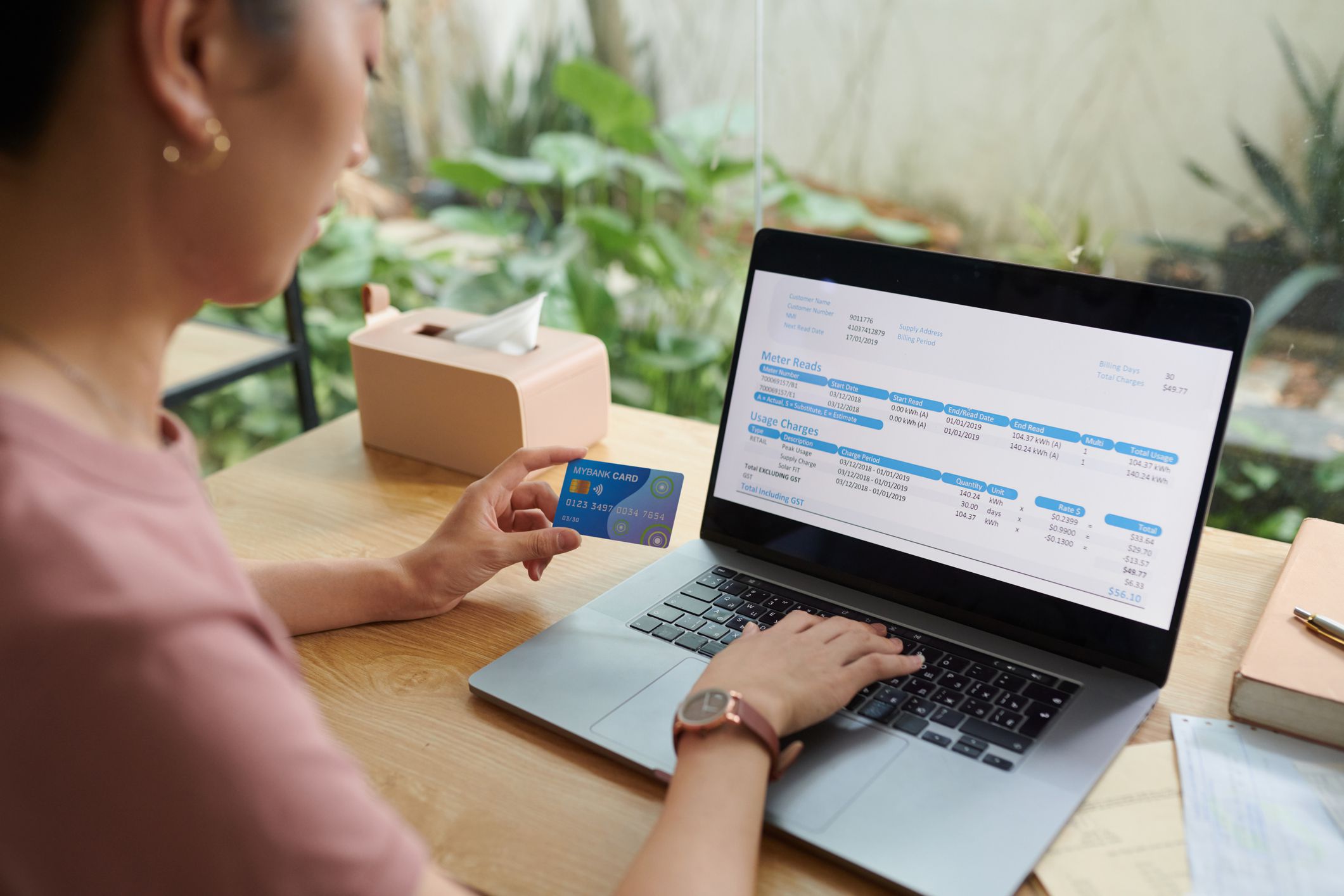 Woman paying utility bills with credit card