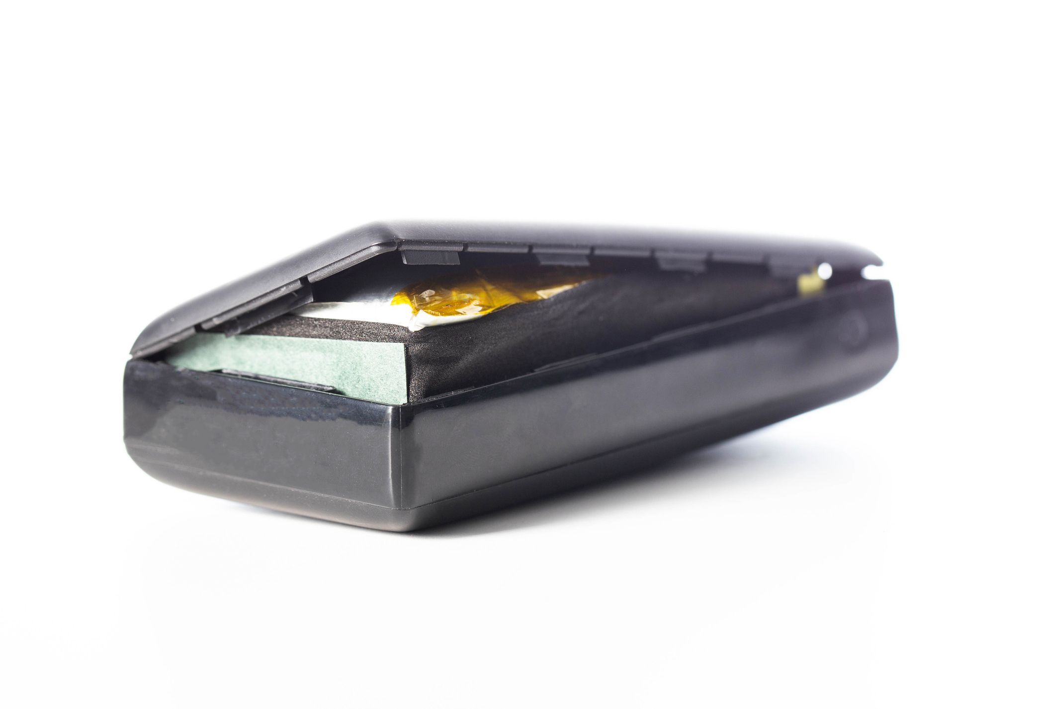 Bloated black power bank on a white background, isolate. Danger of power bank explosion.