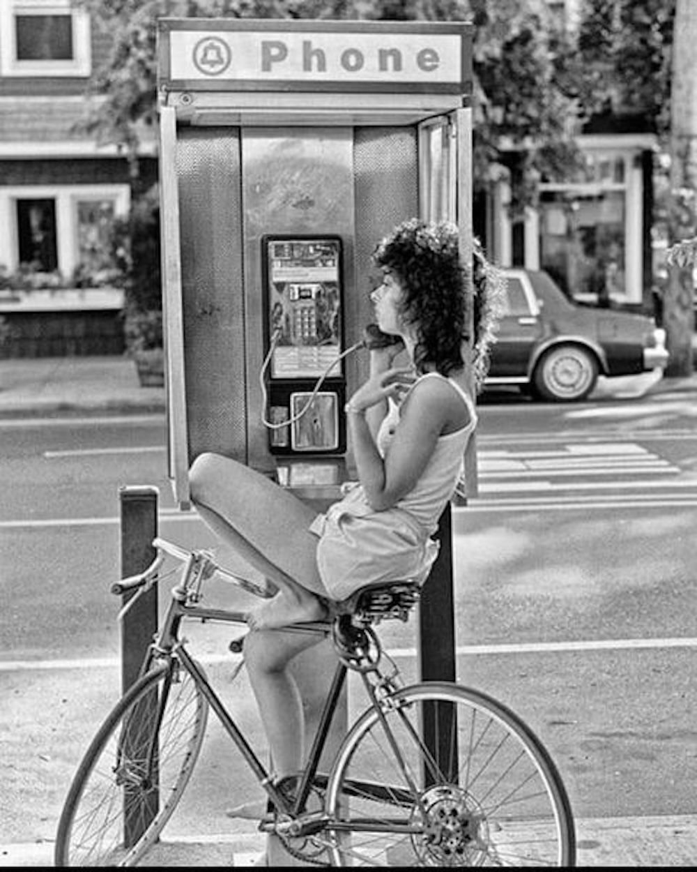 Woman talking on a payphone, 1980s