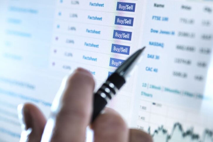 hand of a stockbroker buying and selling shares online
