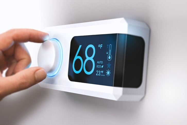 hand adjusting smart thermostat