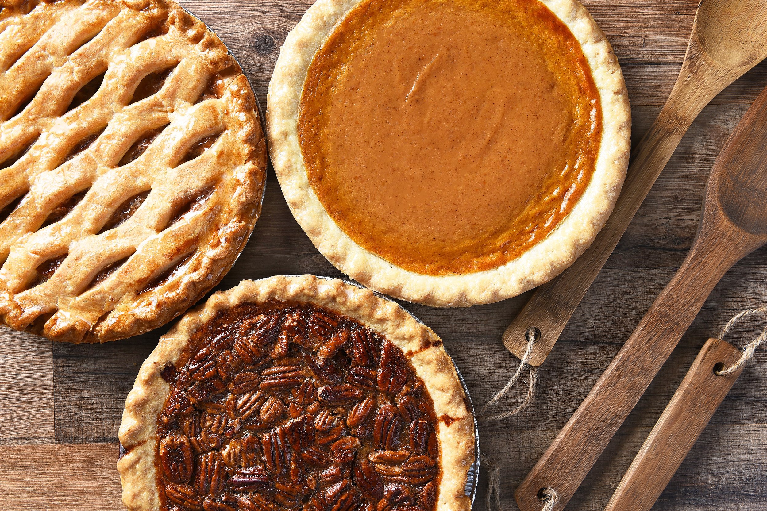 overhead view of three pies: pecan, apple and pumpkin