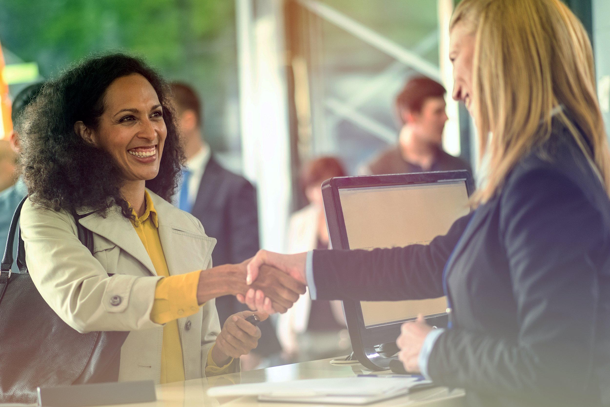 African American woman shaking hands with bank worker