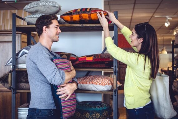 couple shopping for cushions at home decor store