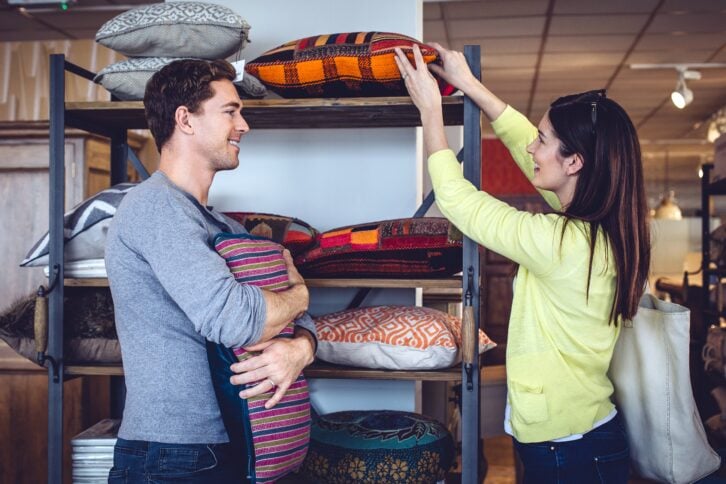 couple shopping for cushions at home decor store