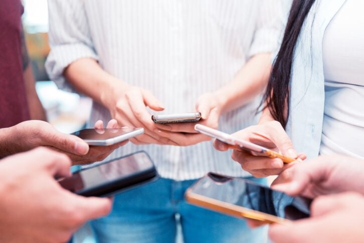 Group of friends on their mobile phones
