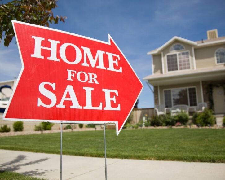 arrow shaped 'Home For Sale' sign
