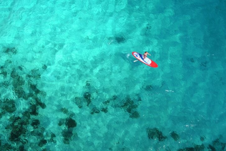 aerial view of woman on paddle board