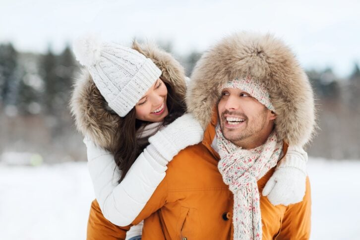 happy couple having fun over winter background