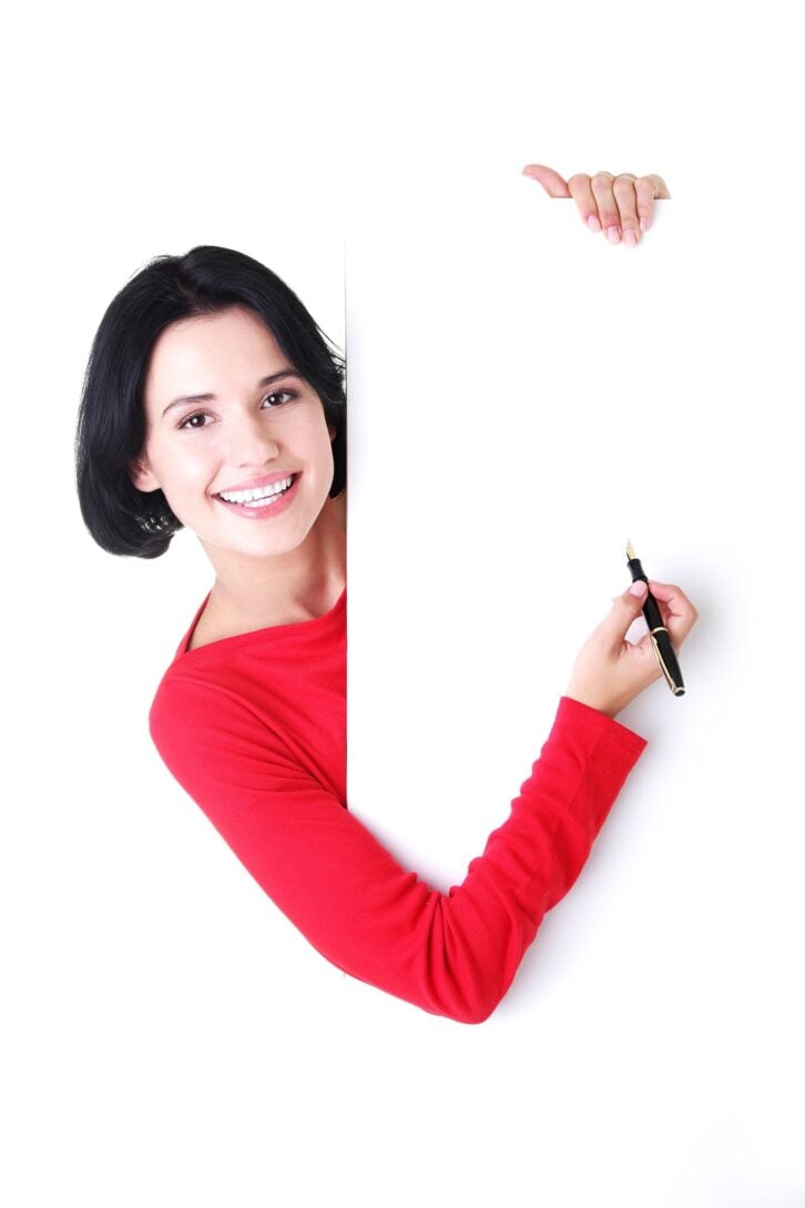 woman writing with a pen on blank board