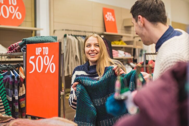couple laughing and shopping in store